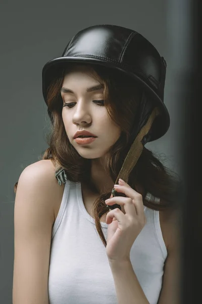 Sensual young girl in military helmet, isolated on grey — Stock Photo