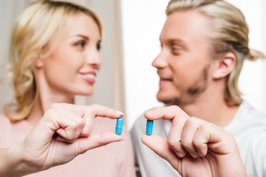 Couple holding pills  clipart