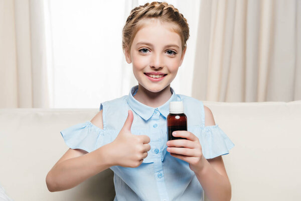 Girl holding medical syrup 