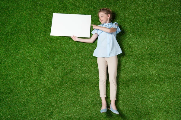 Girl pointing at empty banner — Stock Photo, Image