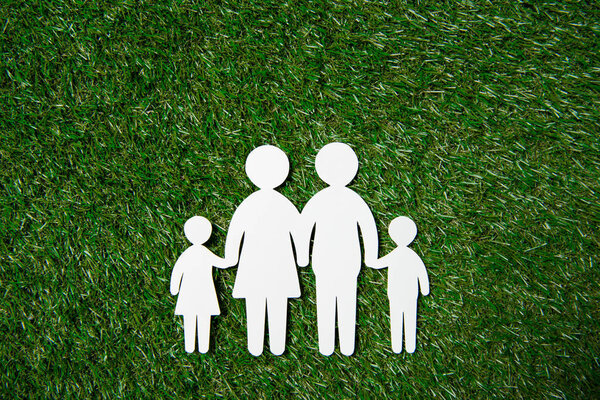 paper cut of family on grass