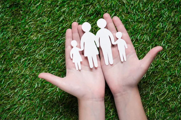Paper cut of family on palms — Stock Photo, Image