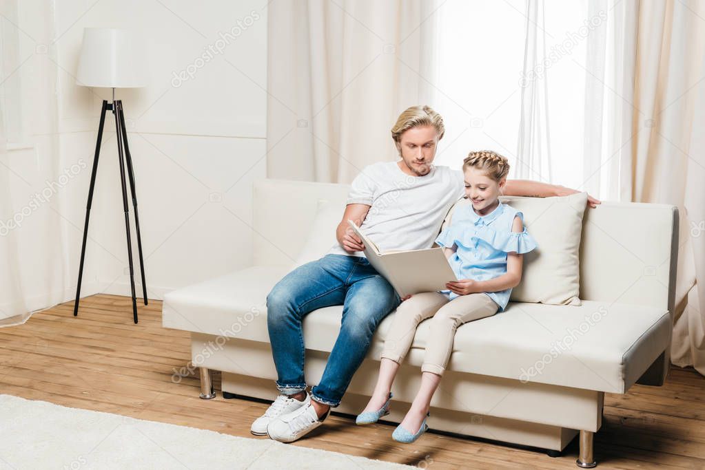 father and daughter reading book