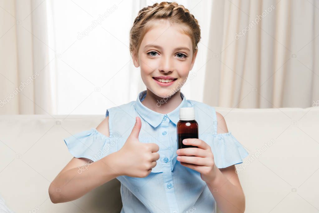 Girl holding medical syrup 