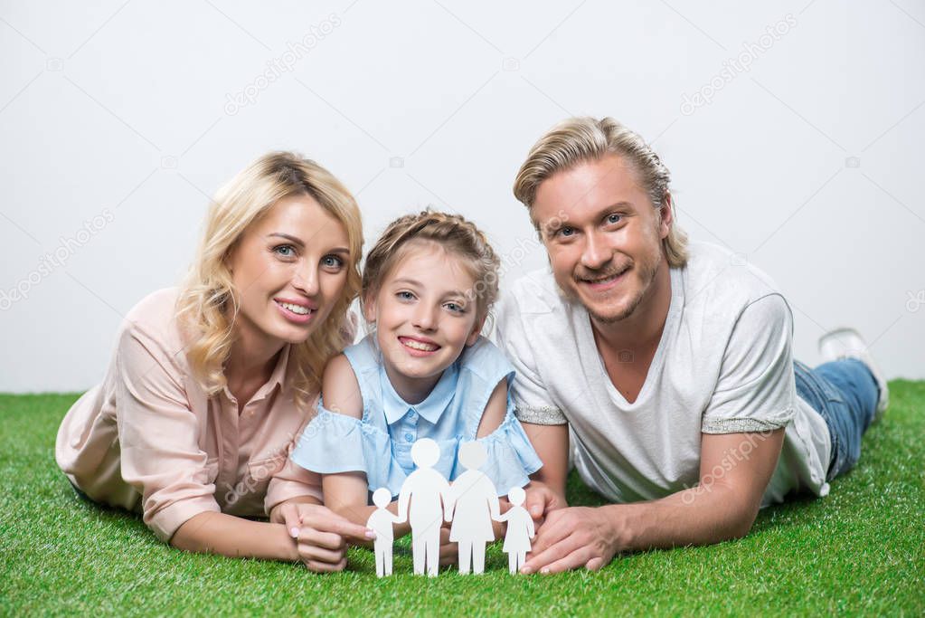 happy family lying on grass