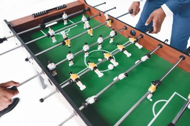 Masa futbolu oynayan iş adamları