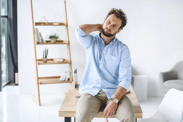 Businessman sitting on table — Stock Photo, Image