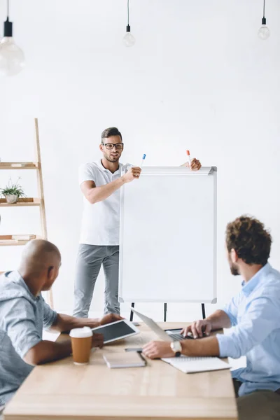 Businessman making presentation to colleagues — Stock Photo, Image