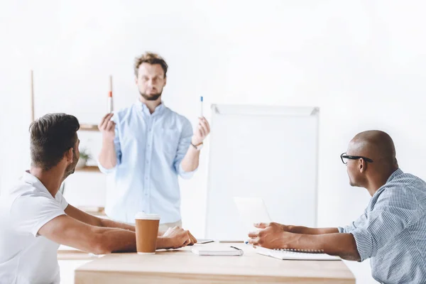 Businessman making presentation to colleagues — Stock Photo, Image