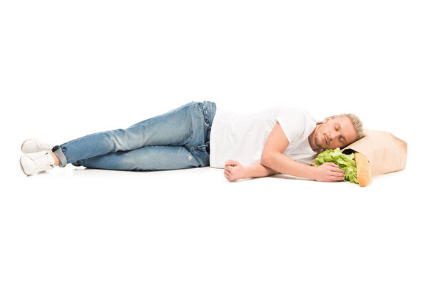 man sleeping on paper bag with food