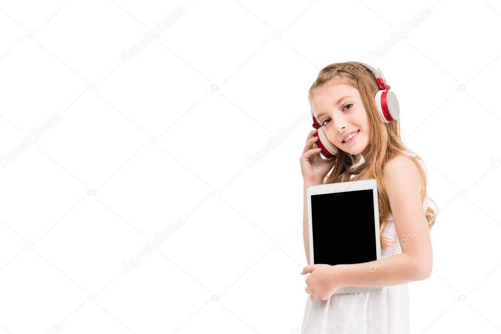 child in headphones with tablet