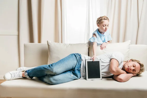 Daughter taking digital tablet — Stock Photo