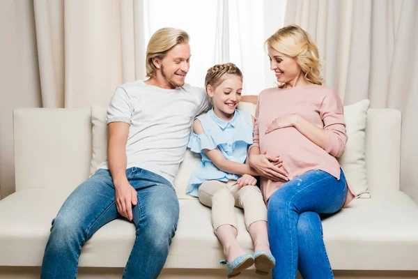 Pregnant woman with husband and daughter — Stock Photo