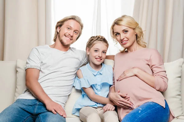 Pregnant woman with husband and daughter — Stock Photo