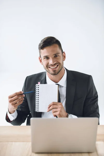 Businessman pointing at notebook — Stock Photo