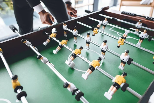 Businessman playing table football — Stock Photo