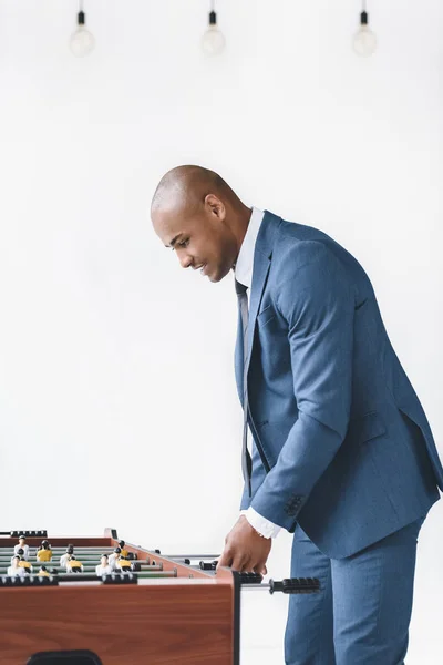 Businessman playing table football — Stock Photo