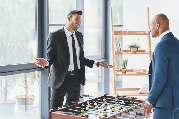 Businessmen playing table football — Stock Photo