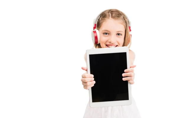 Child in headphones with tablet — Stock Photo