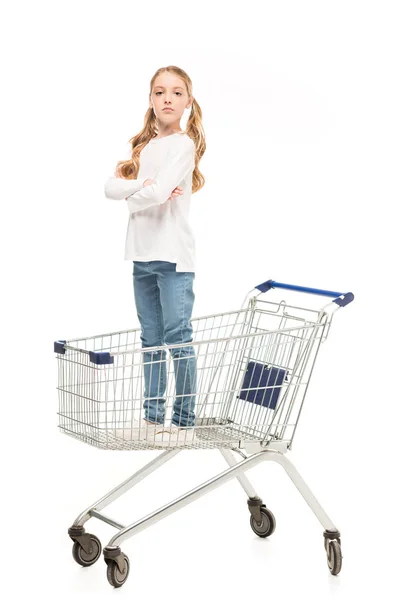 Kid standing in shopping cart — Stock Photo