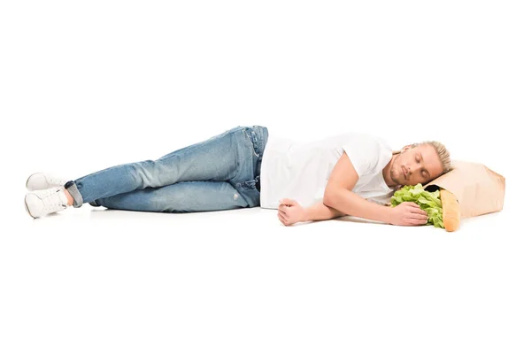 Man sleeping on paper bag with food — Stock Photo