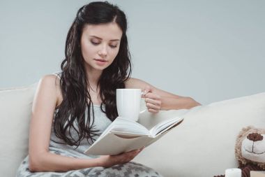 Young woman reading book 