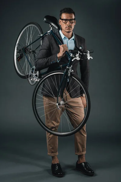 Businessman in formal wear holding bicycle — Stock Photo, Image