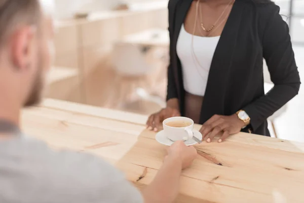 Waiter giving cup of coffee — Stock Photo, Image