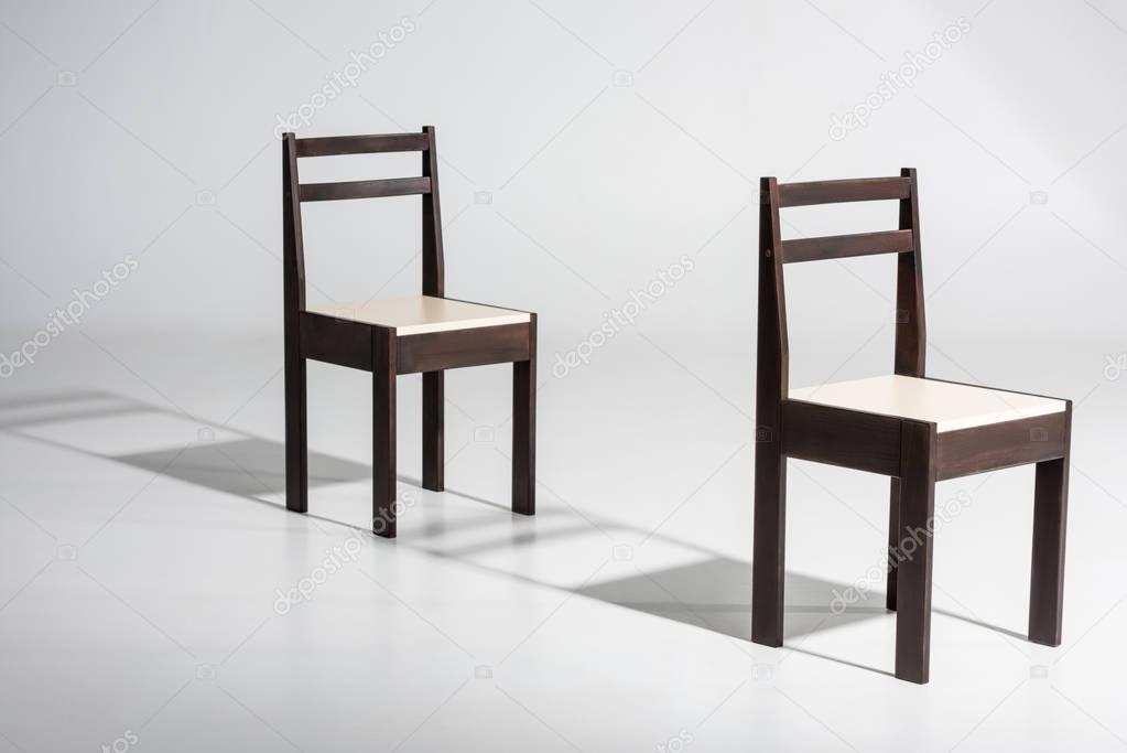 dark wooden chairs in row