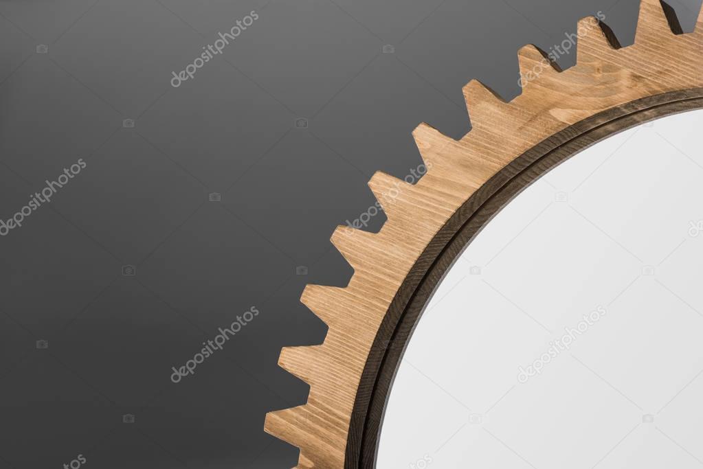 mirror framed by wooden cogwheel
