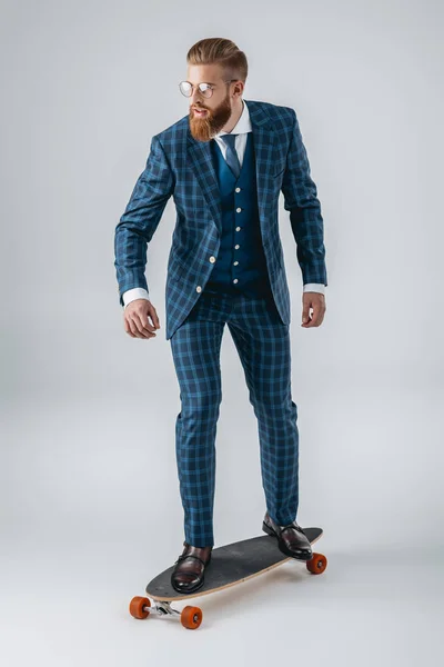 Fashionable man in suit on skateboard — Stock Photo, Image