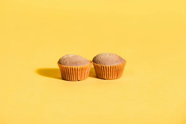 Homemade muffins on yellow — Stock Photo, Image
