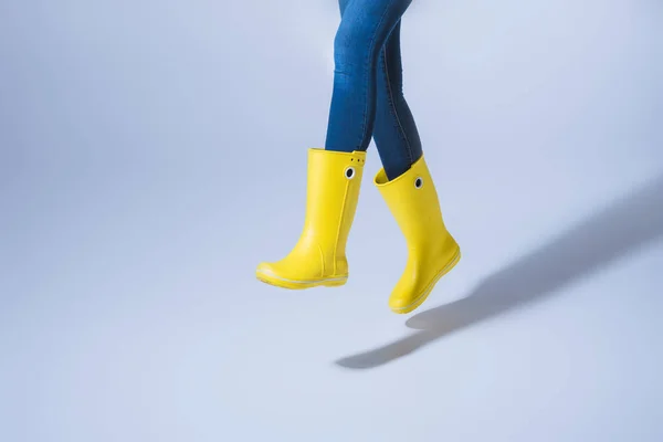 Woman jumping in rubber boots — Stock Photo, Image