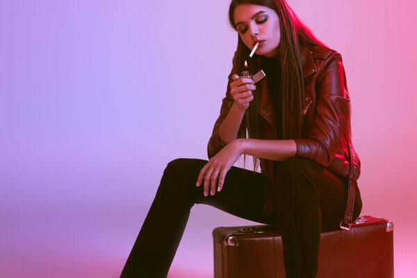 smoking girl sitting on suitcase