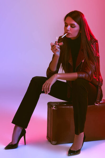 smoking girl sitting on suitcase 