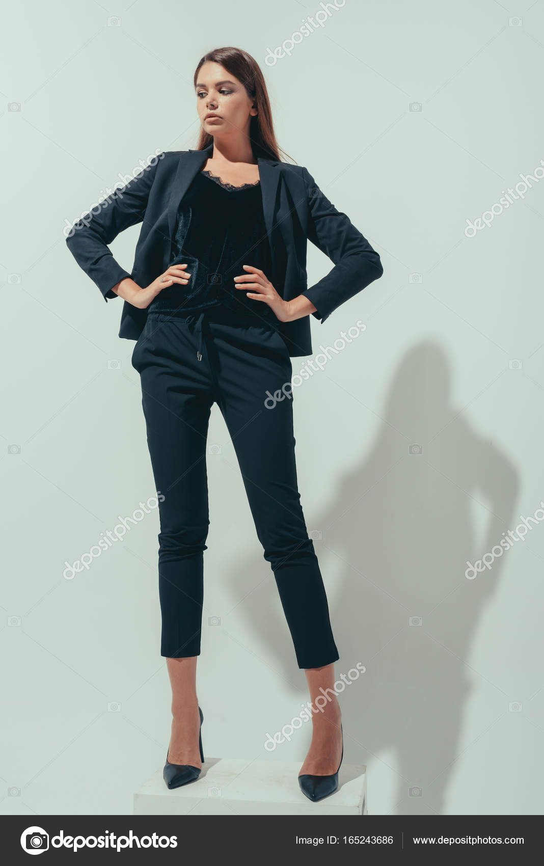 Girl posing in suit Stock Photo by ©VitalikRadko 165243686