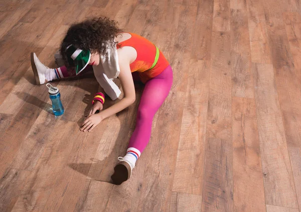 Beautiful woman stretching on floor — Stock Photo, Image