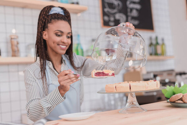 barista holding piece of pie
