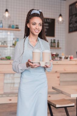barista holding holder with disposable cups clipart
