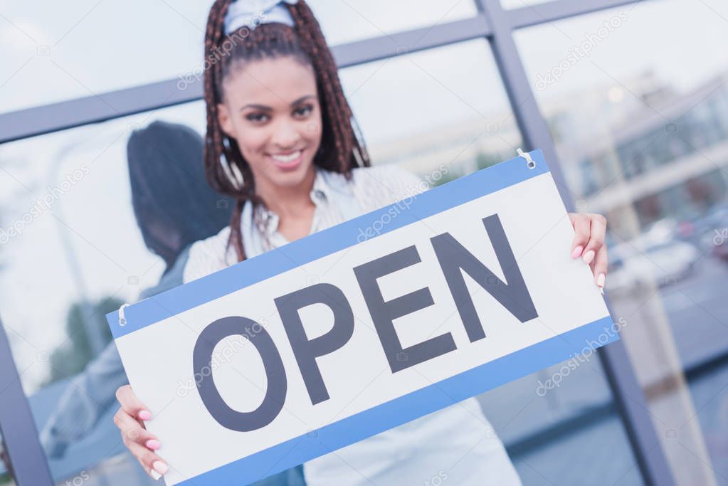 barista holding Open sign 