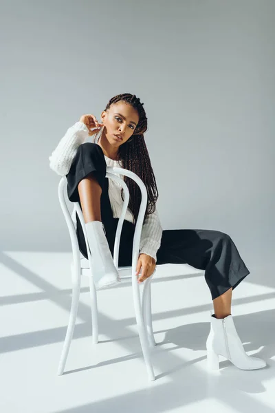 Trendy african american girl with chair — Stock Photo, Image