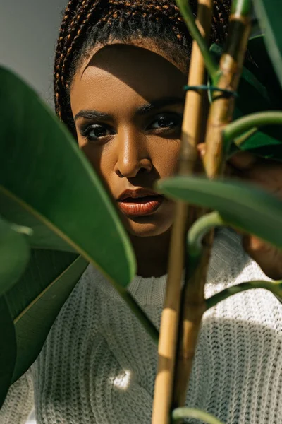 African american girl with green leaves — Stock Photo, Image