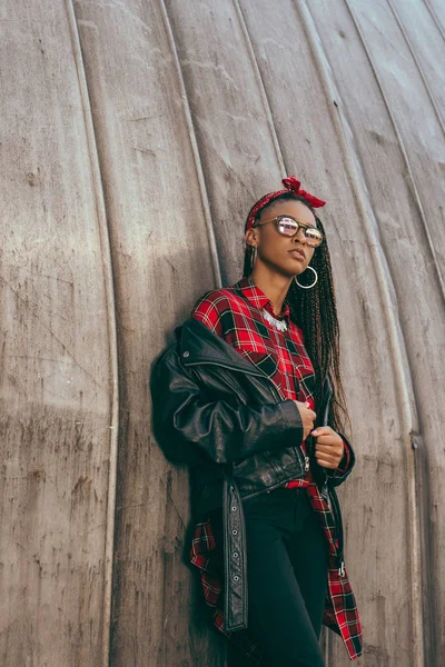 Girl in leather jacket and checkered shirt — Stock Photo, Image