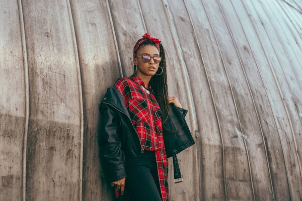 Girl in leather jacket and checkered shirt — Stock Photo, Image