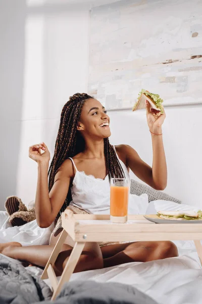 Woman eating breakfast in bed — Stock Photo, Image