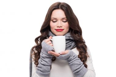 woman in warm clothes smelling coffee clipart