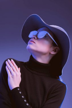Model in wide-brimmed hat and sunglasses clipart