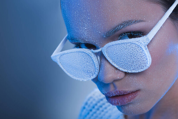 woman in sunglasses covered in frost