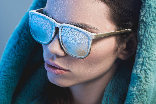 woman with frost on face wearing sunglasses