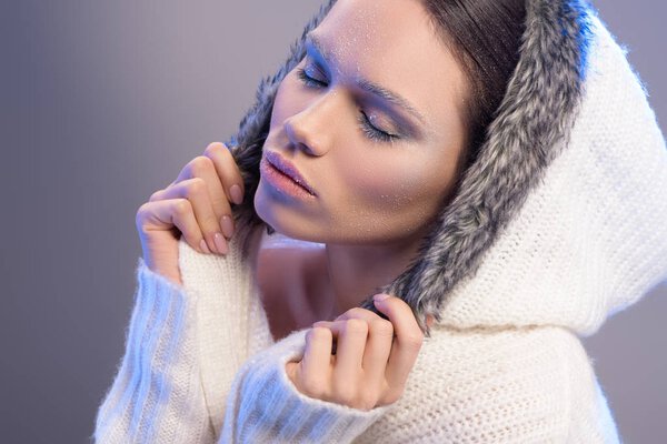Young woman in hooded sweater